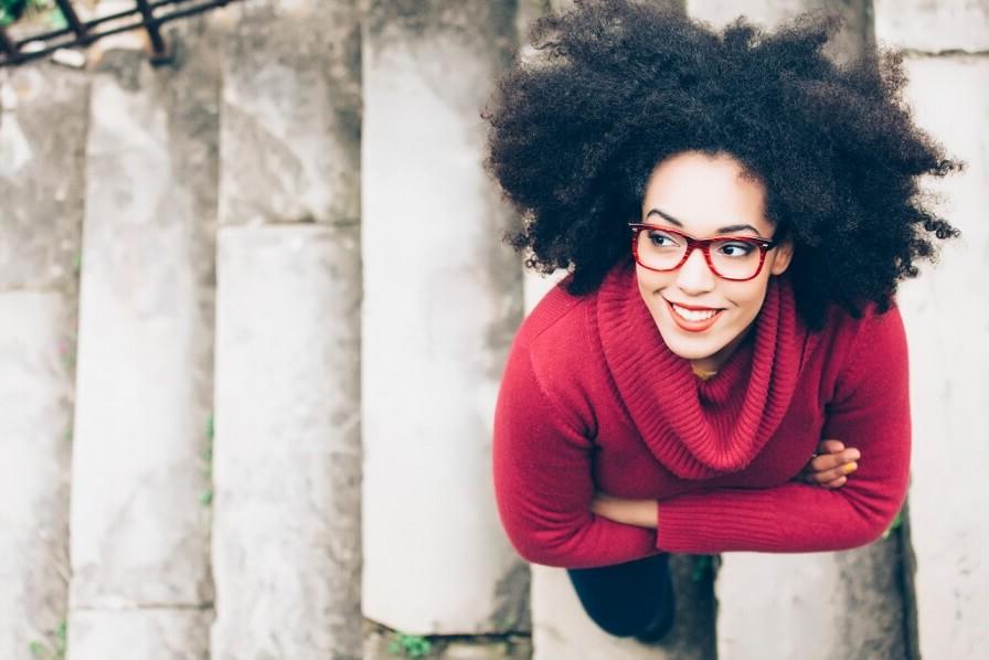 Woman with glasses walking up stairs